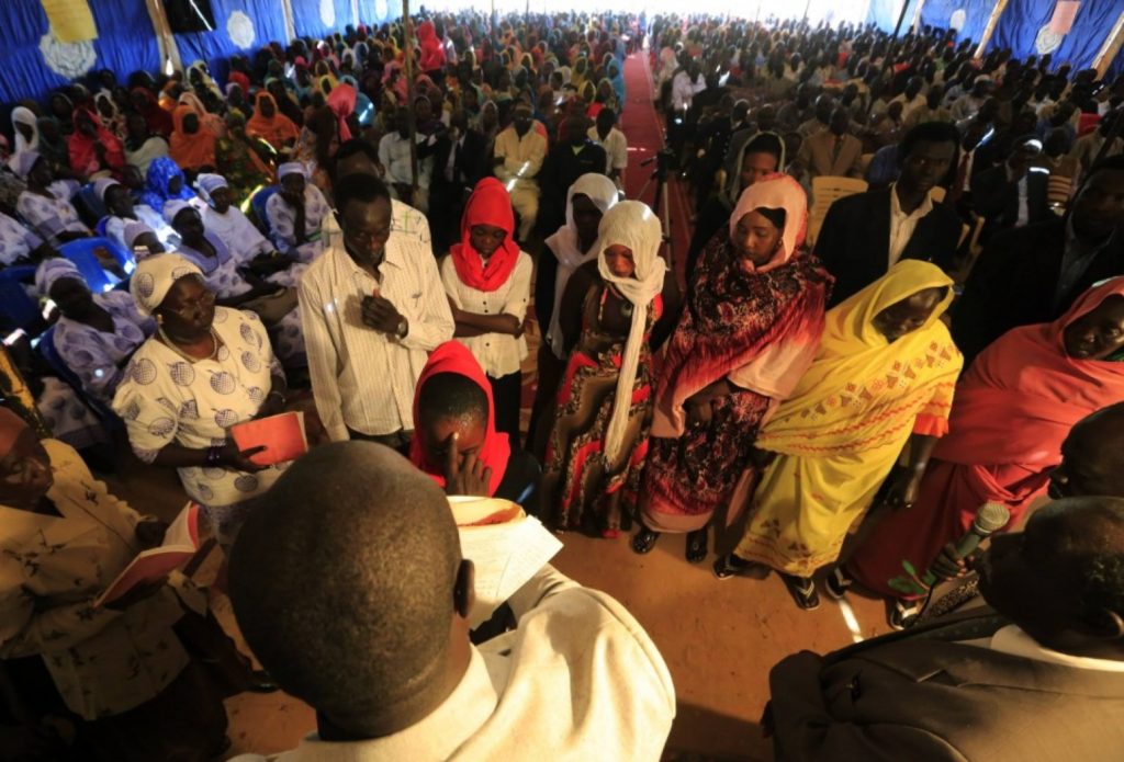 Members of the Nuba tribe from South Kordofan state receive blessings from a priest during Christmas celebrations at a church in Omdurman, Sudan, in 2013. (Mohamed Nureldin Abdallah/Reuters)